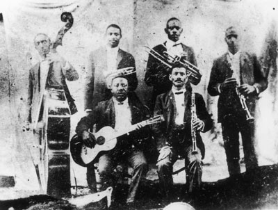 Pictured: Top: Jimmy Johnson (bass), Bolden (cornet), Willy Cornish (Valve Trombone), Willy Warner (Clarinet) Bottom: Brock Mumford (Guitar), Frank Lewis (Clarinet)