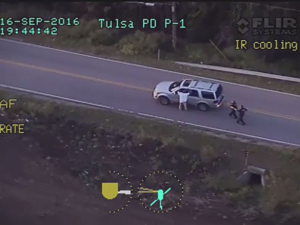Credit: image released by the Tulsa Police Department, shows Crutcher with his hands raised moments before Shelby opens fire.