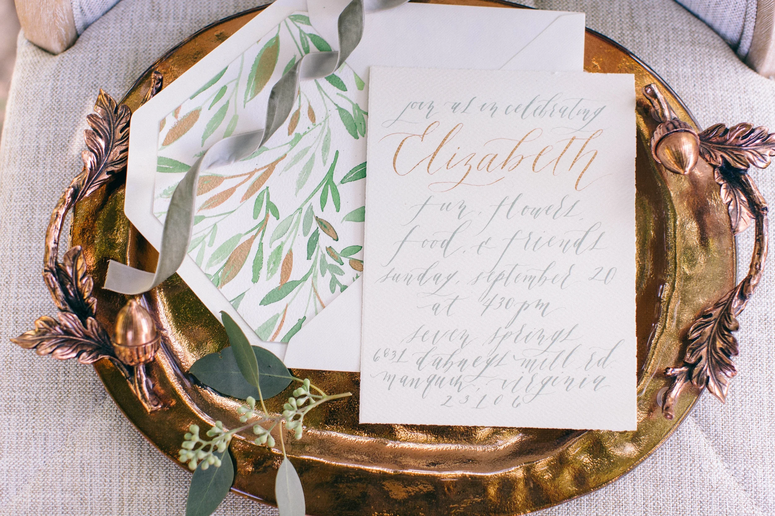 Invitation suite display on a tray.