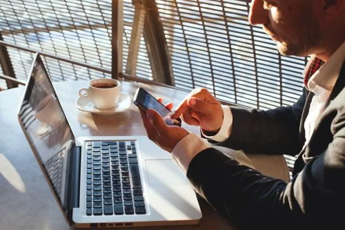 shutterstock_215260810_ID_Web_Businessman_Cell_Phone_Lap_Top_lowrez.jpg