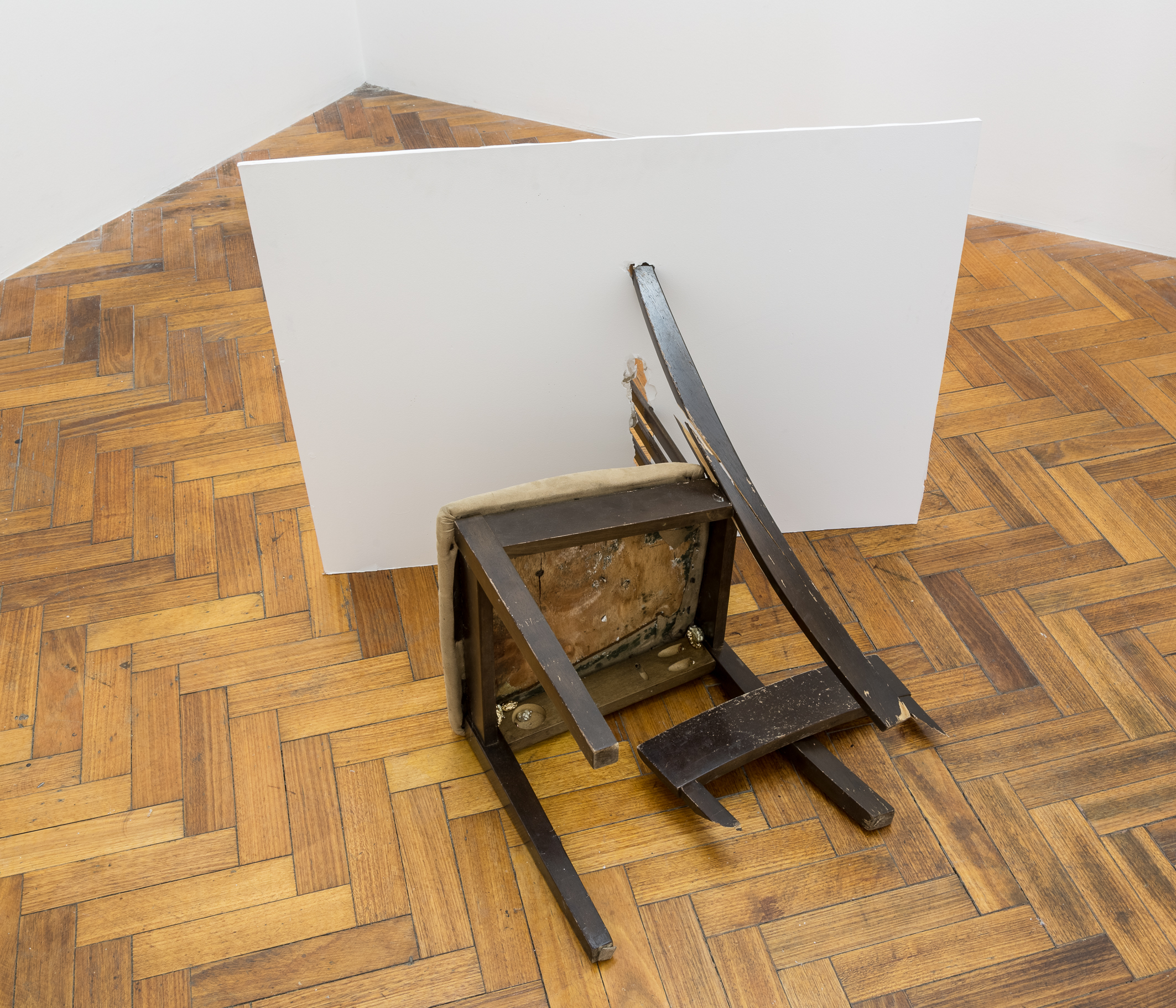A chair thrown in anger , wooden chair with padded seat, plasterboard, gold plated pewter and pewter casts of Grape flavoured Hubba Bubba bubble gum chewed by the artist, 60 x 90 x 85cm, 2017