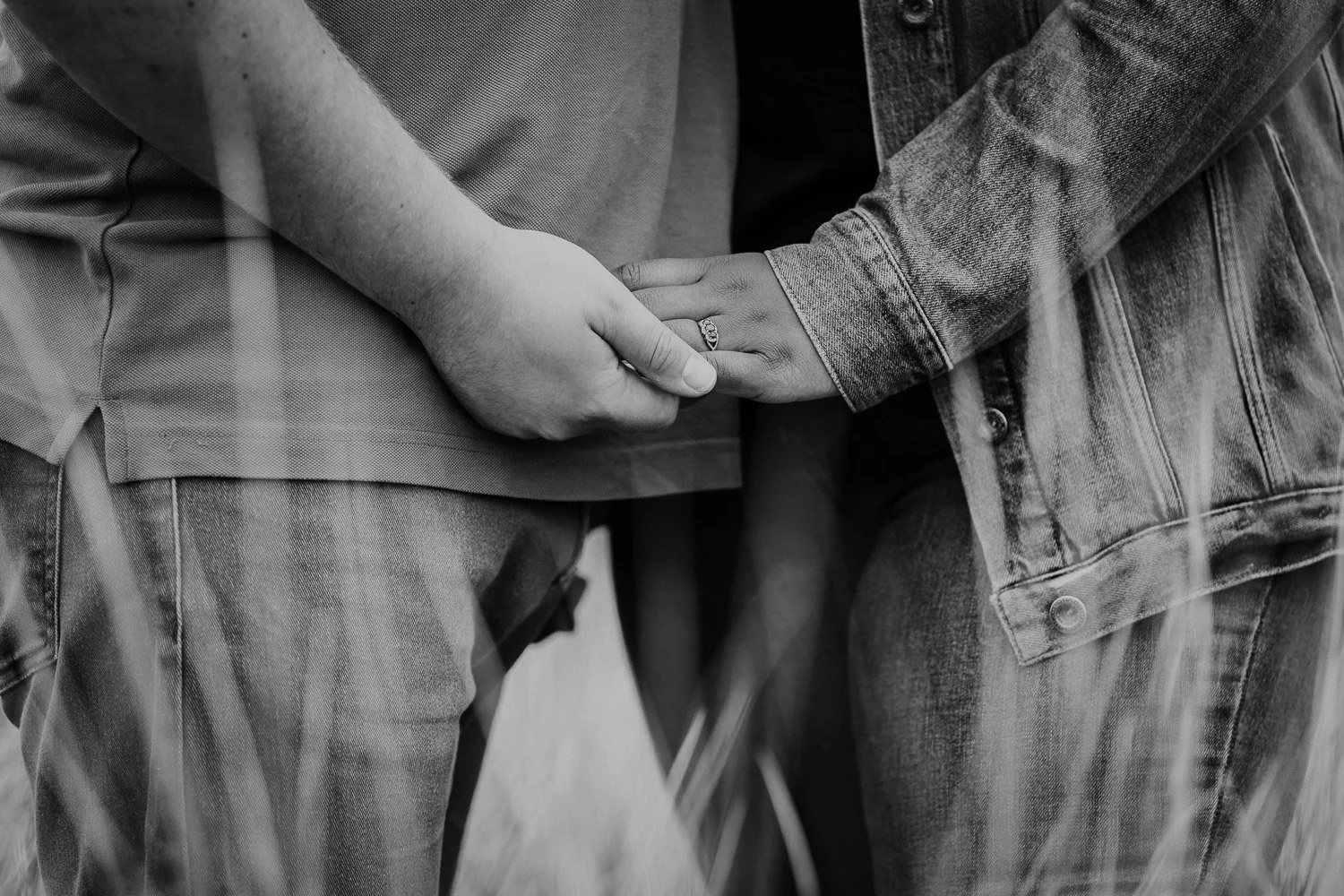Close up of couple holding hands with focus on engagement ring taken during Couple Portrait Session