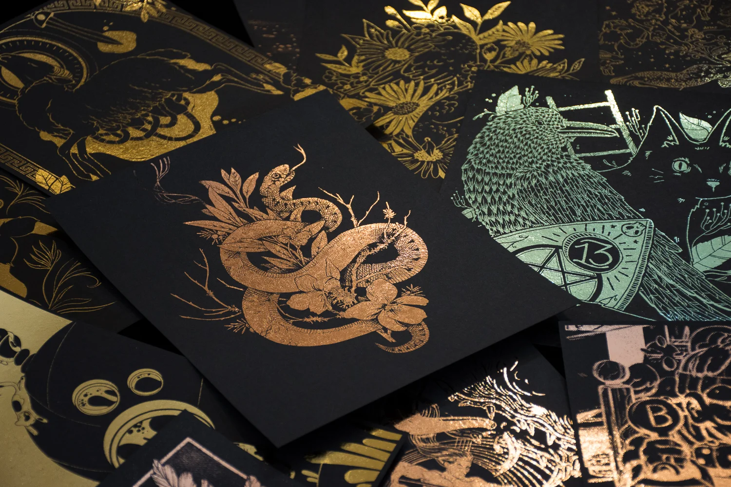 fig. 4. The rose gold foiled snake & sage print between artworks from participating artists (photo by Light Grey Art Lab)