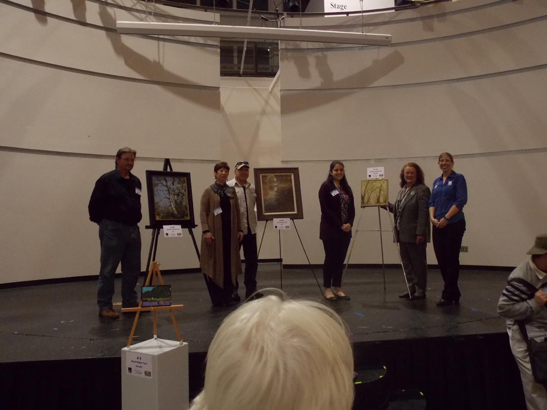 Marty Coulter's painting (center), Natalie Rupp's painting (right), and Lon Brauer's painting (left).