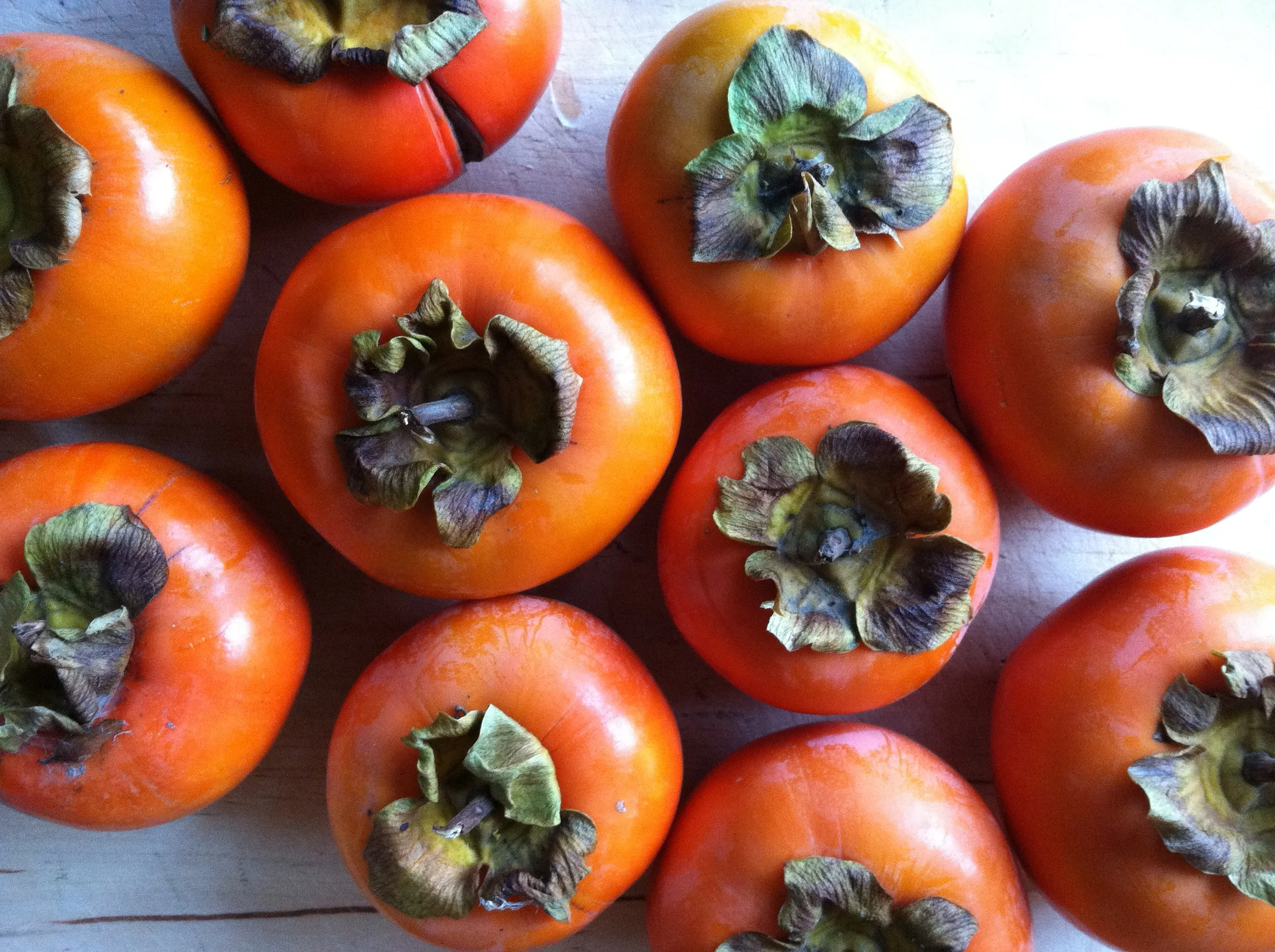 Persimmons!  It's not a tomato.