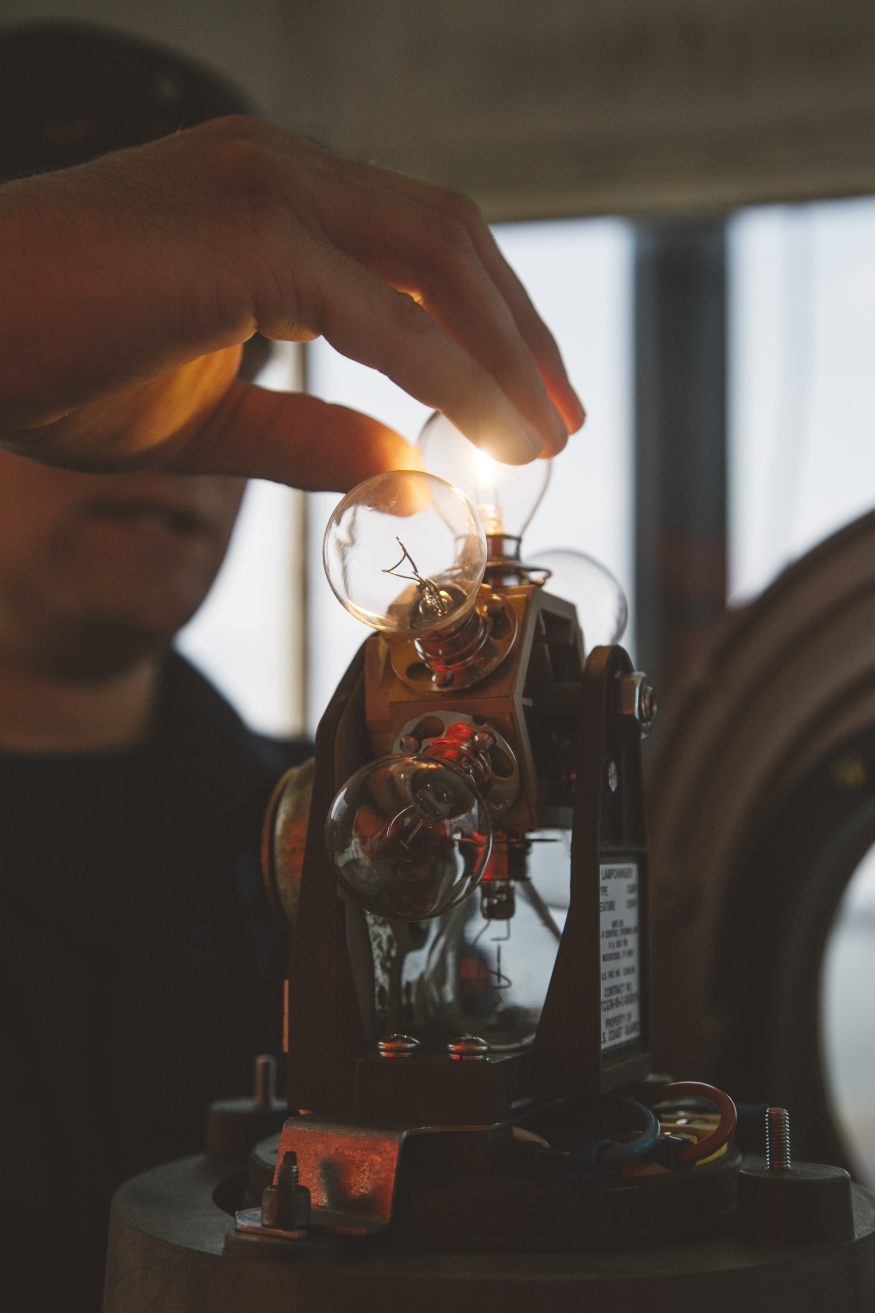 Em1 Tony Robb fixes a light at Spring Point Ledge Light. Photo © Jenny Rebecca Nelson