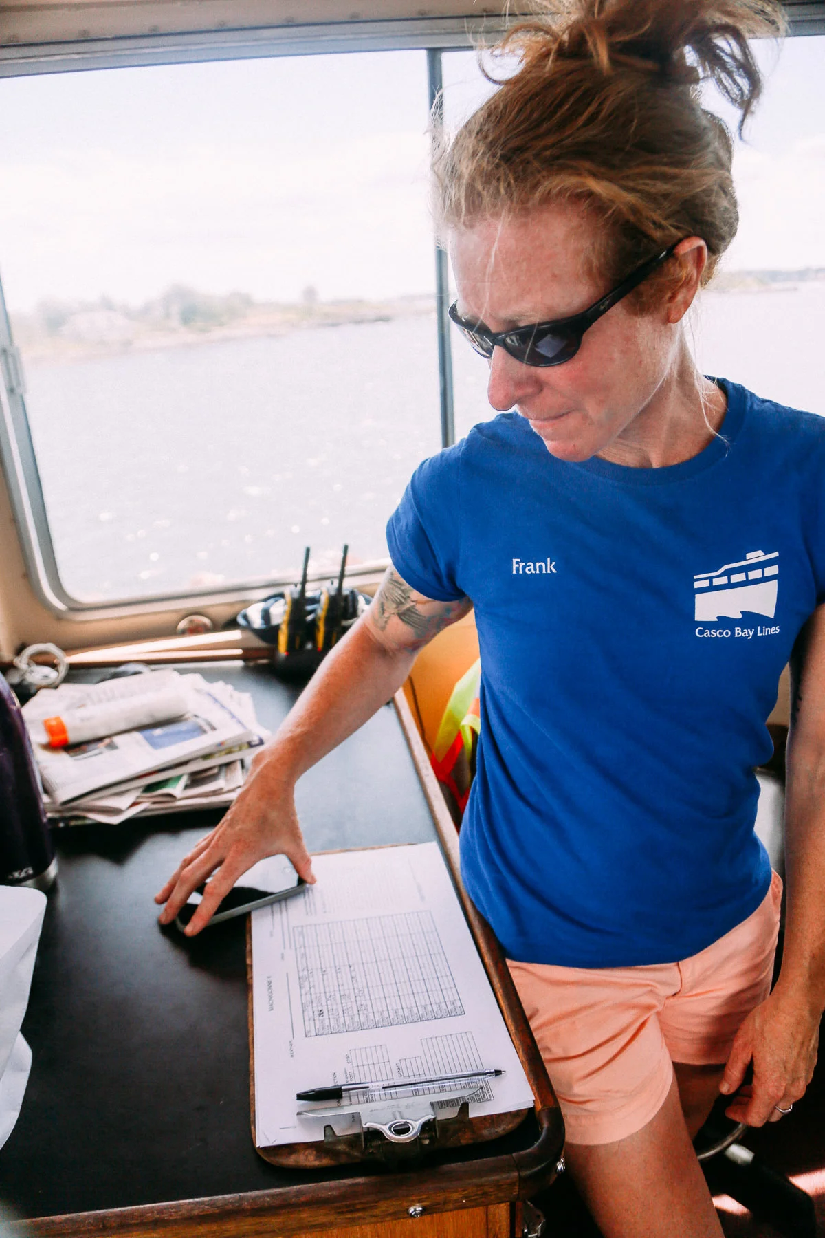 Gretchen Frank looks at the Machigonne II log book. Photo by Justin Levesque © 2016. 