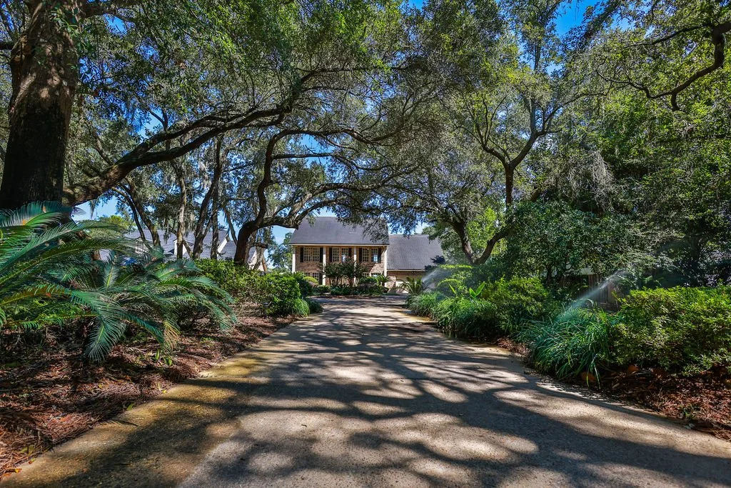 tree lined driveway to large waterfront home in for walton beach