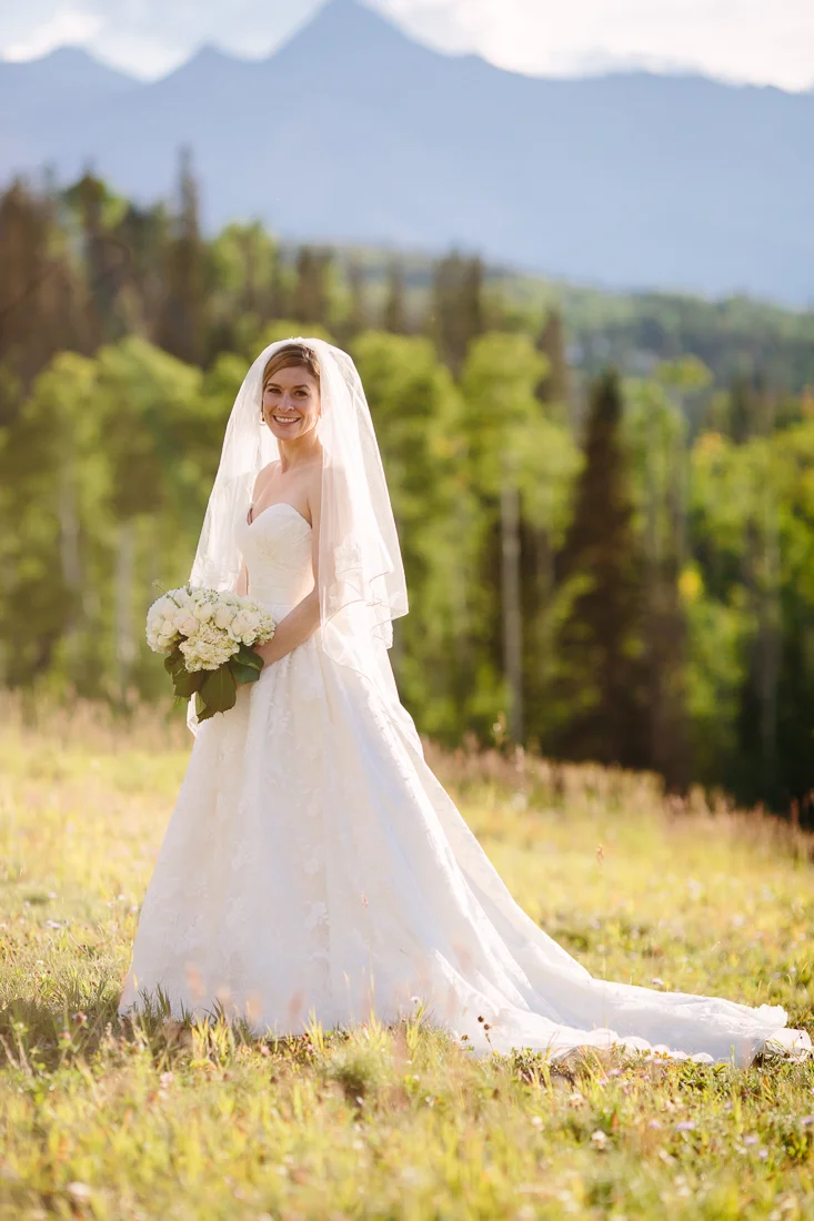 Cat Mayer Studio | http://www.catmayerstudio.com | Gorrono Ranch Wedding Photographer | Bride in field with Colorado mountain backdrop