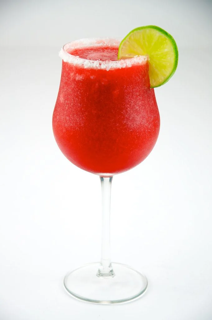 The Daquiri - A popular choice in the summertime, the daiquiri is refreshing, social, fun, and cool. It's made simply with lime juice, sugar, and rum, but can also be filled with frozen fruits like banana or strawberry.