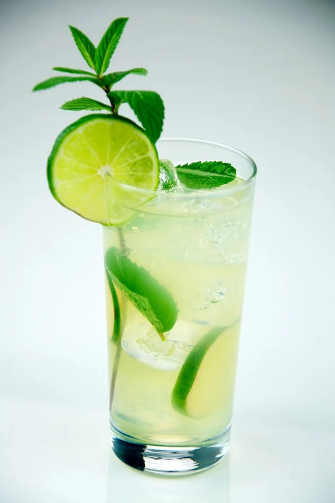 The Mojito - Ordering a mojito is regular for those on a tropical vacation or trying to reminisce/dream about one. It signifies that you're refined and looking to have a fun time. It contains mint, fresh lime juice, rum, sugar, and club soda.