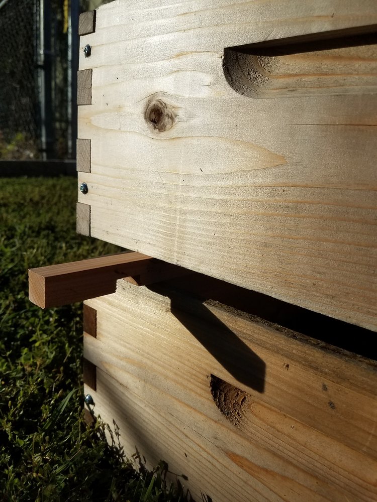 Use an entrance reducer as a sort of wedge to help as you remove upper hive bodies.