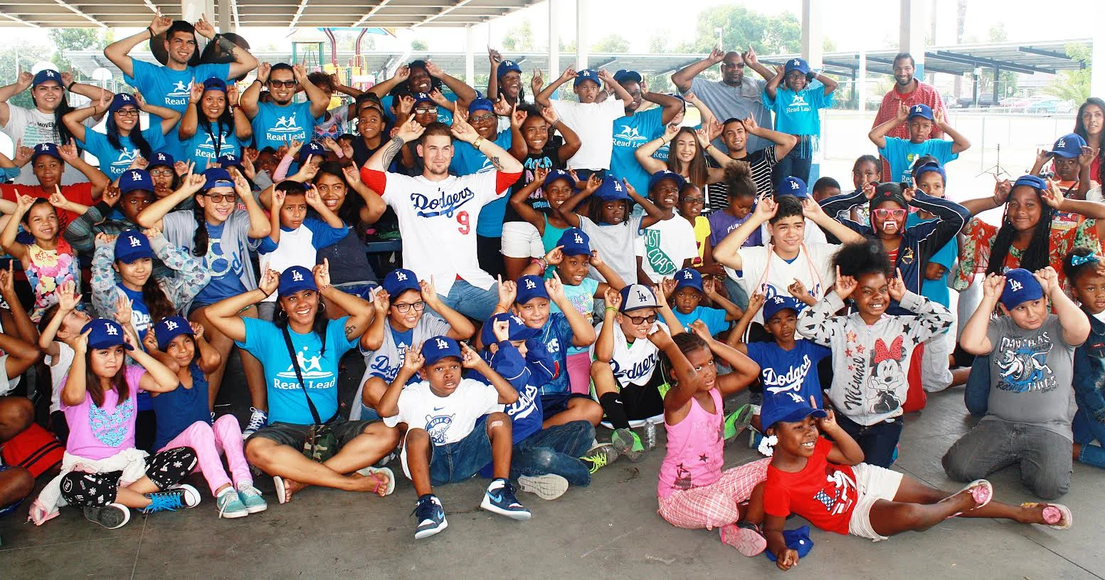 More than 100 students at Lynwood Unified’s Helen Keller Elementary School sit with Dodgers catcher Yasmani Grandal on Friday, July 31. The students are all posing with horns in honor of Grandal who is nicknamed “Tasmanian Devil.”