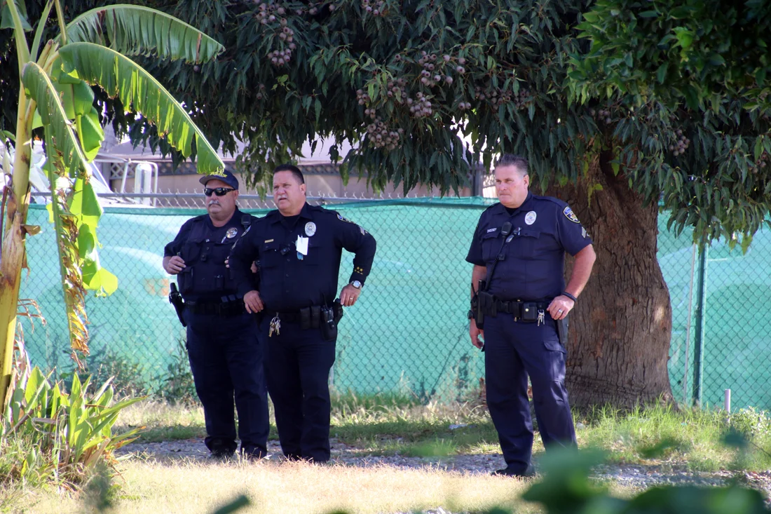Police officers monitor clean-up efforts at the Rives Mansion on Wednesday. Photo by Eric Pierce