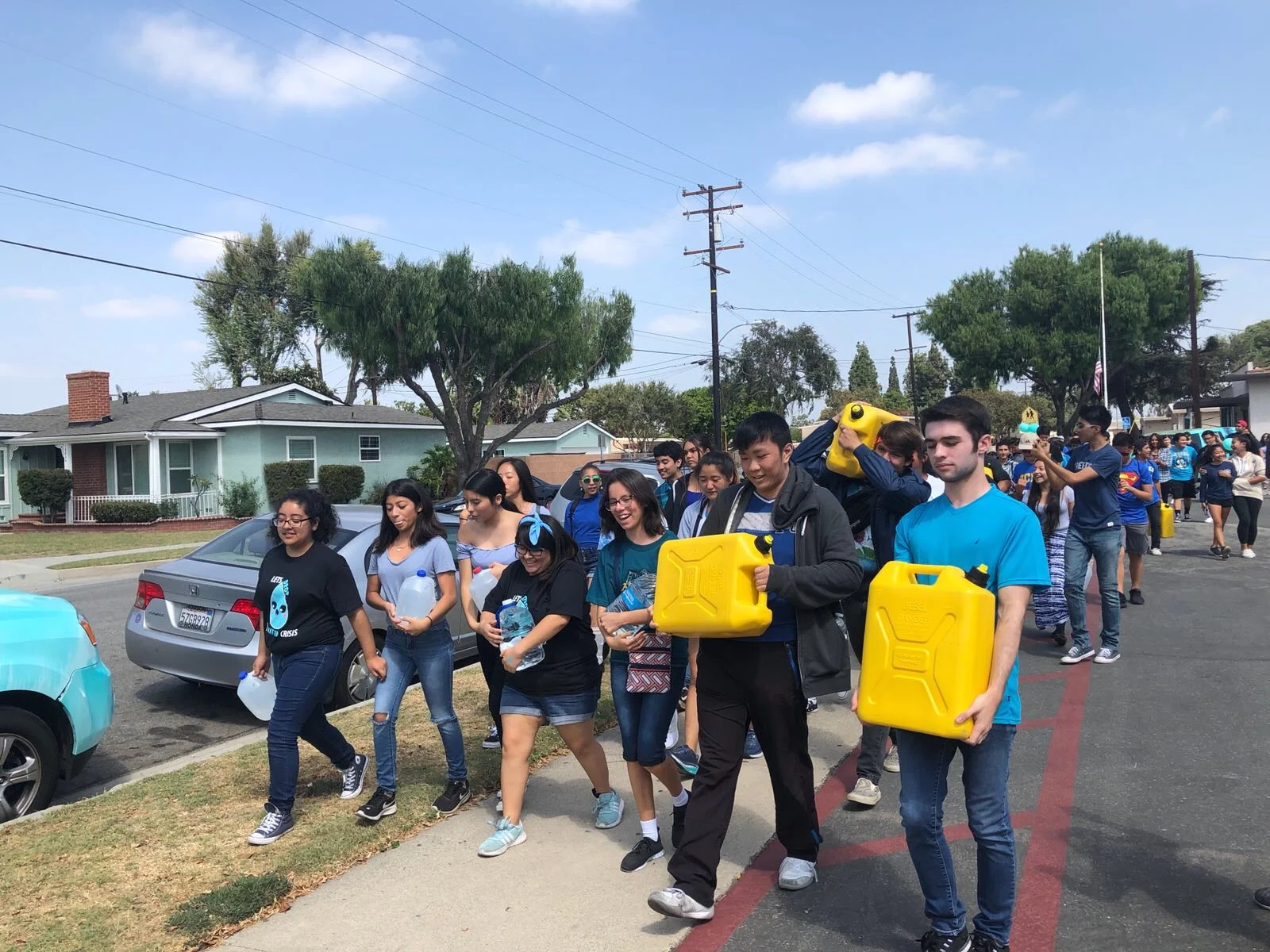 Students carried 44-lb. jugs to symbolize the arduous journey people make daily around the world to secure clean water. Photo by Mark DeJesus, Diamond Division Technology Chair