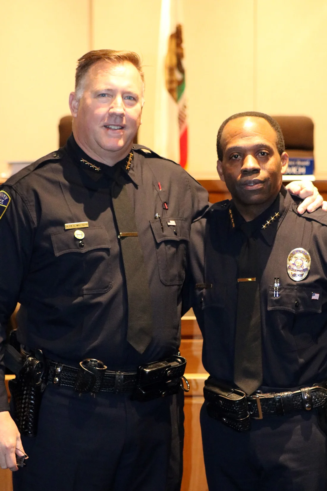 Police Chief Dean Milligan and former Police Chief Carl Charles. Photo by Alex Dominguez
