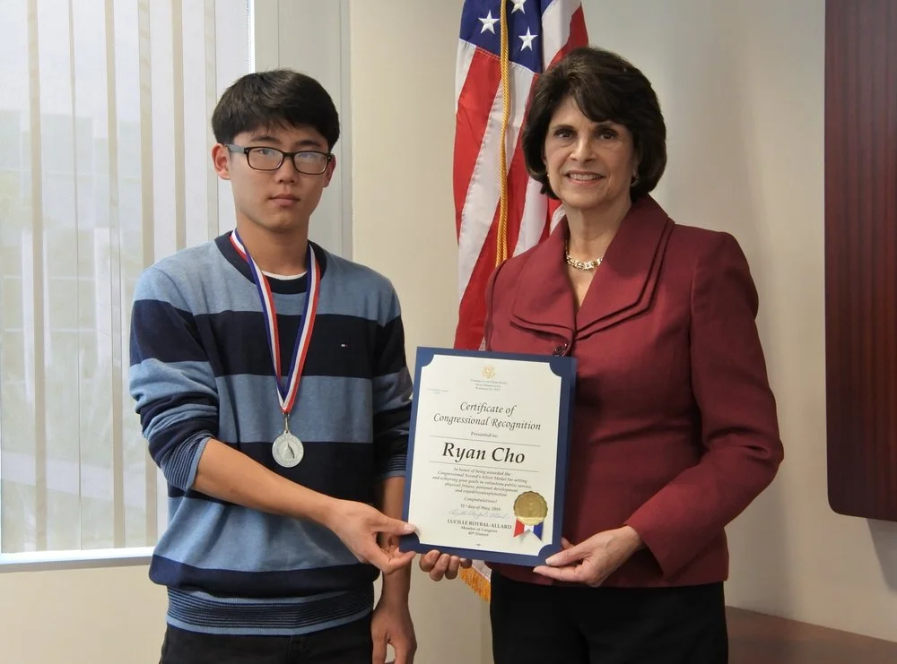 Ryan Cho, left, receives a certificate of congressional recognition from Rep. Lucille Roybal-Allard.