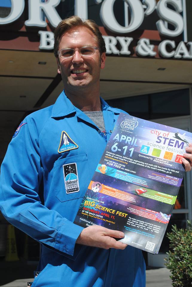Ben Dickow holds promotional material for a prior City of STEM festival.