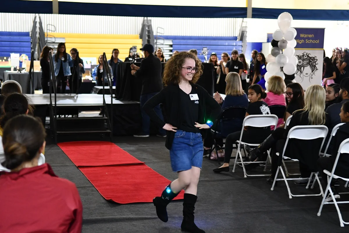 A student models wearable technology created by the Femineers, a female-focused engineering program in Downey Unified.