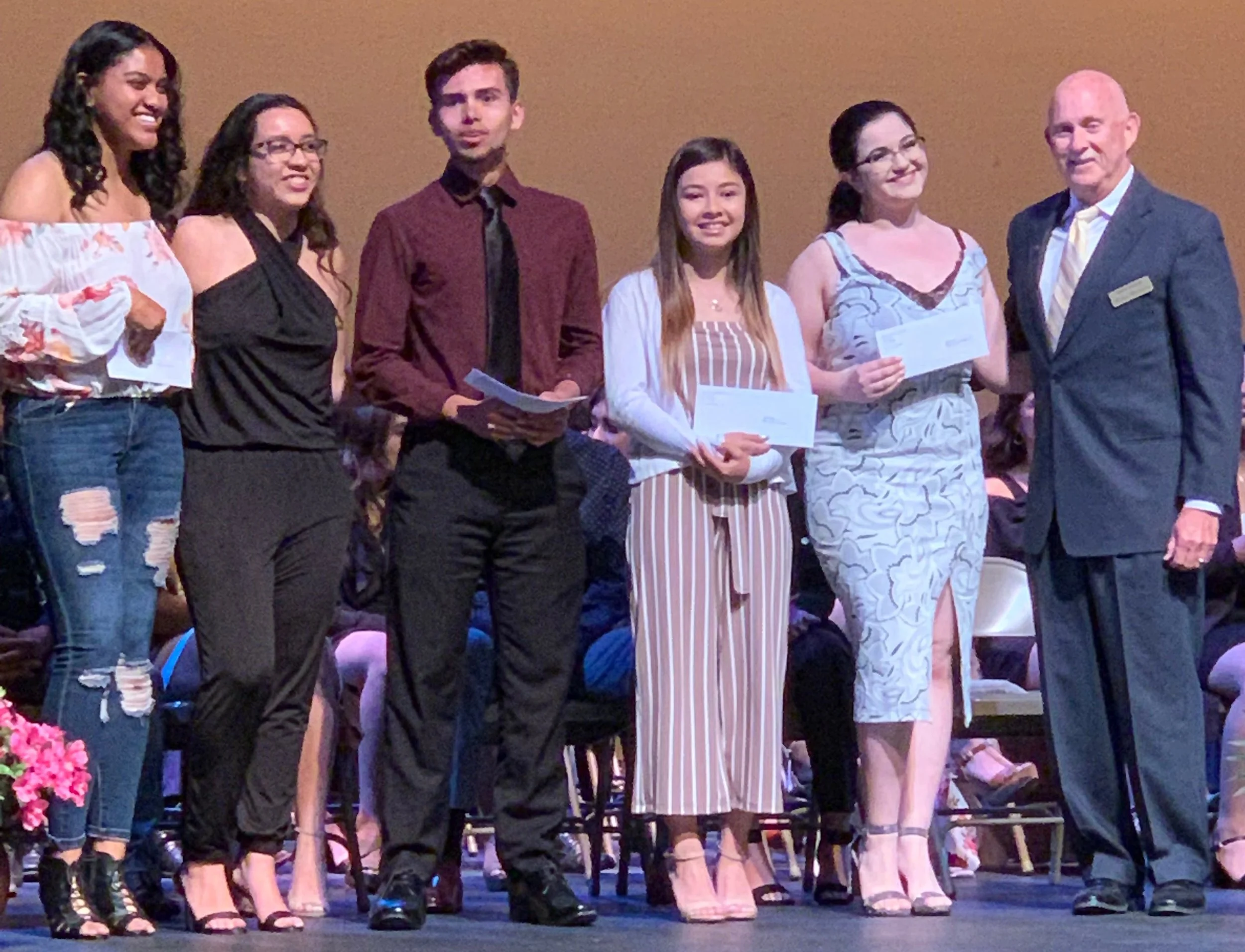 Greg Welch, right, with the five Warren High School scholarship recipients.