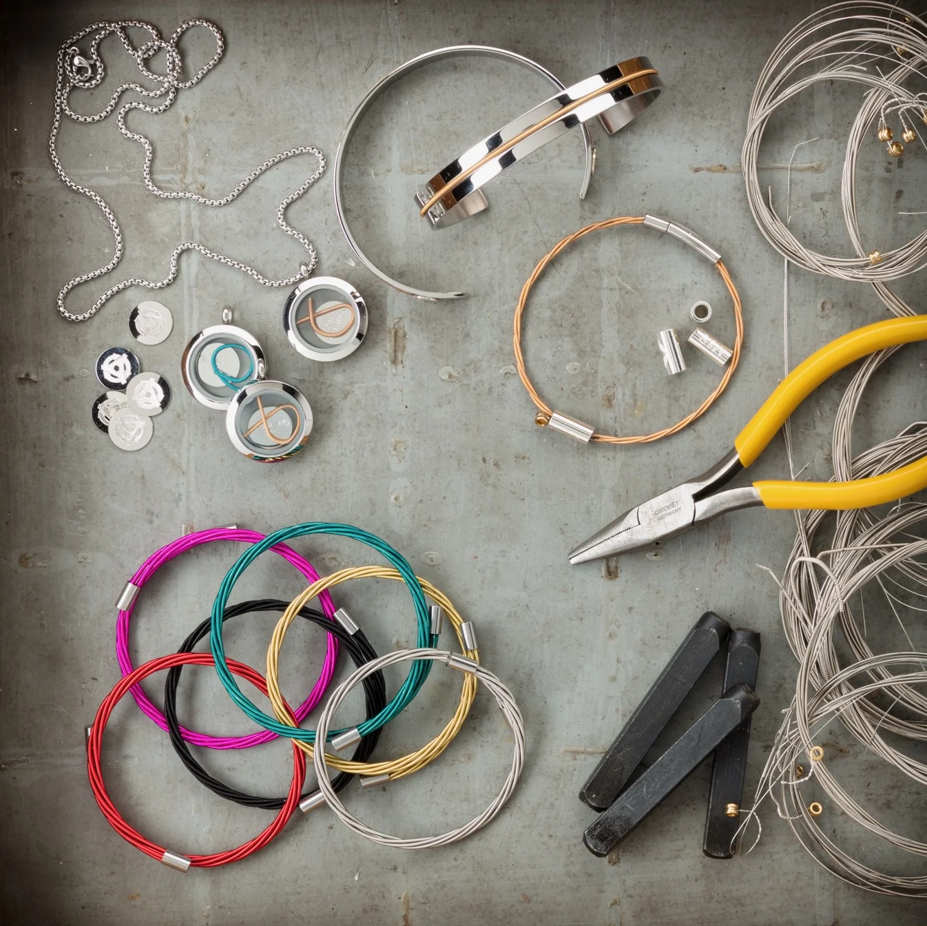 guitar string jewelry Designing jewelry that could be made from donated guitar strings—of unstandardized and unpredictable metals—proved to be a challenge to produce as well as to create. The solution was melding industrial production with hand-crafting, and the result is pendants, bracelets and cuffs that are comfortable to wear, long lasting and beautiful to the eye.