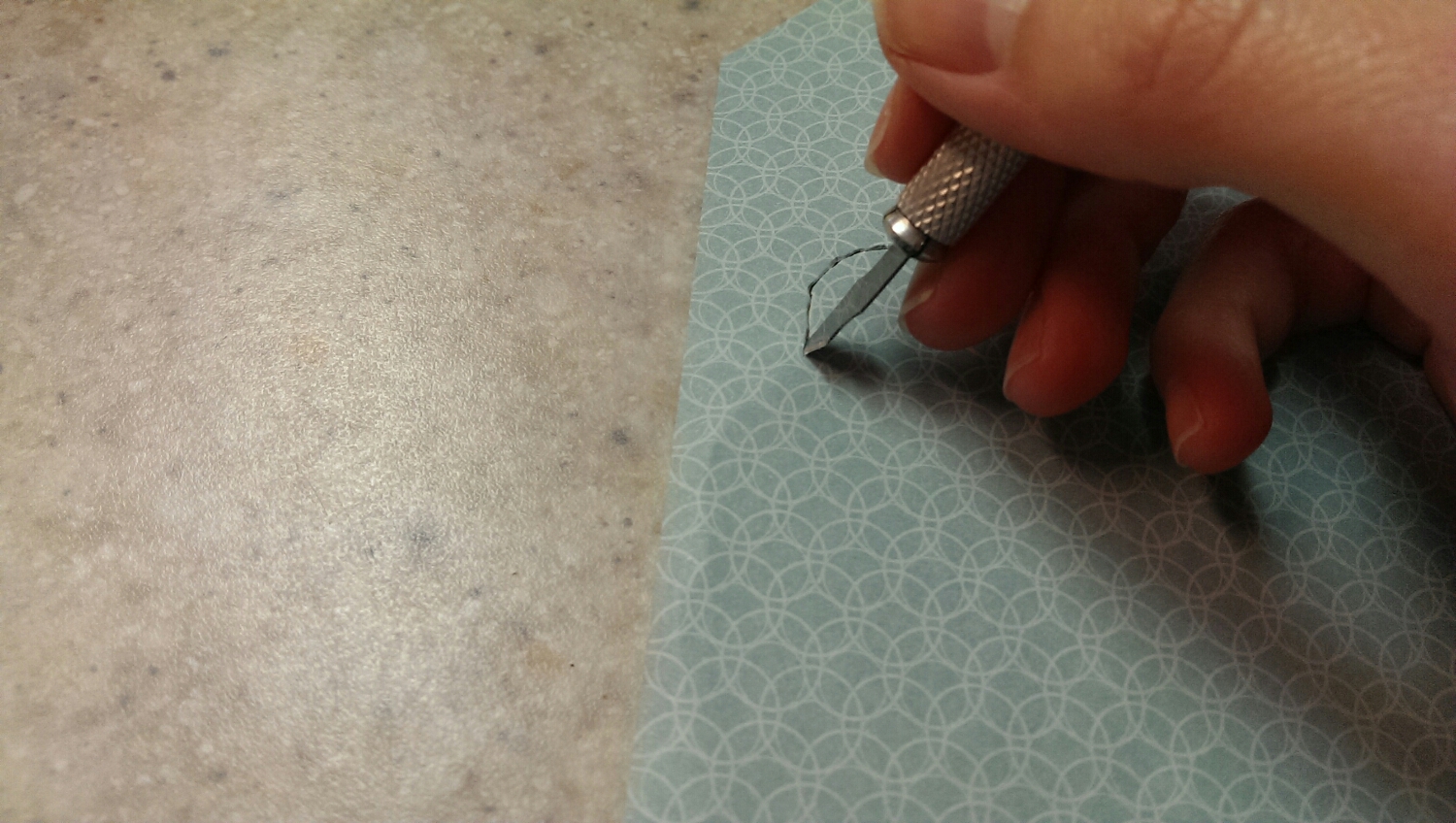 Trimming the scrapbook paper.