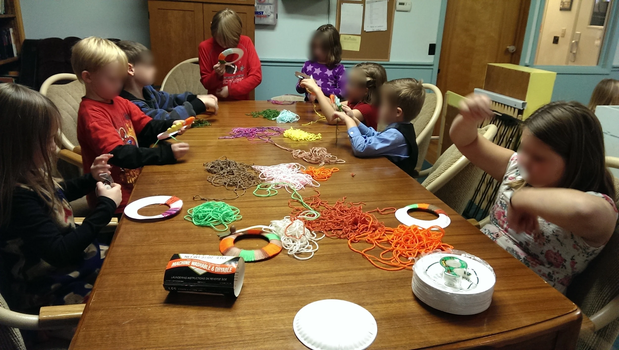 The kids are busily wrapping the yarn around their wreaths.