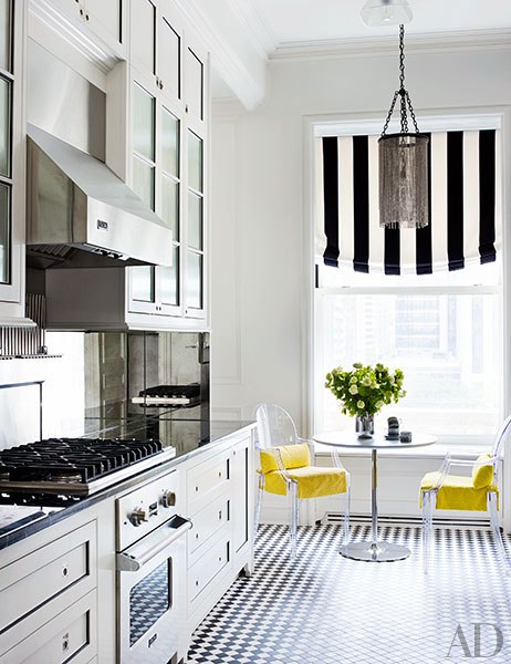 yellow chairs in black and white kitchen