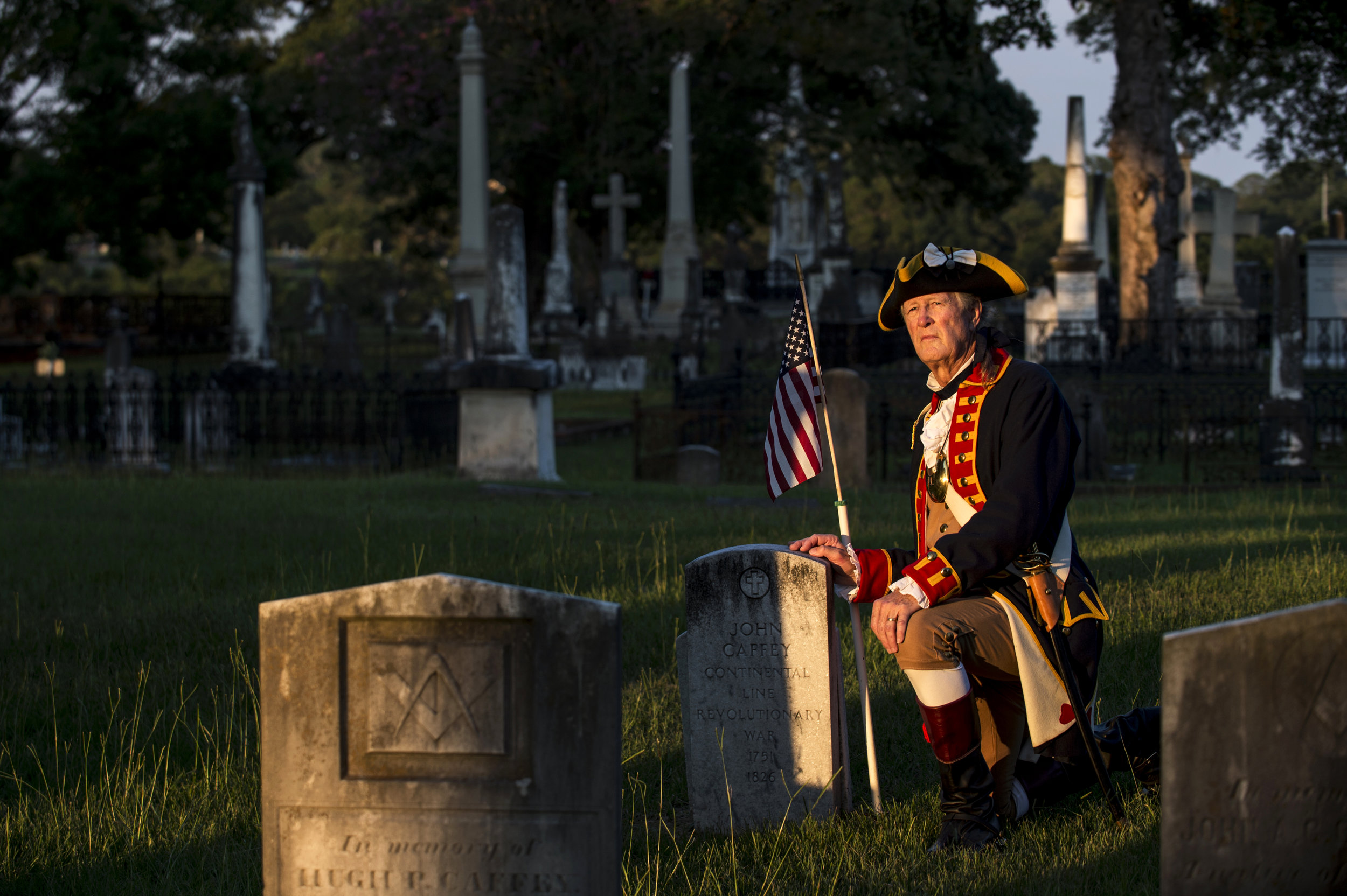Larry Cornwell poses for a portrait next to the grave of John Caffey, who fought in the Revolutionary War, at Oakwood Cemetery in Montgomery, Ala. Cornwell is the Genealogist General for the Sons of the American Revolution, and has located six graves of Revolutionary War patriots buried in Montgomery.