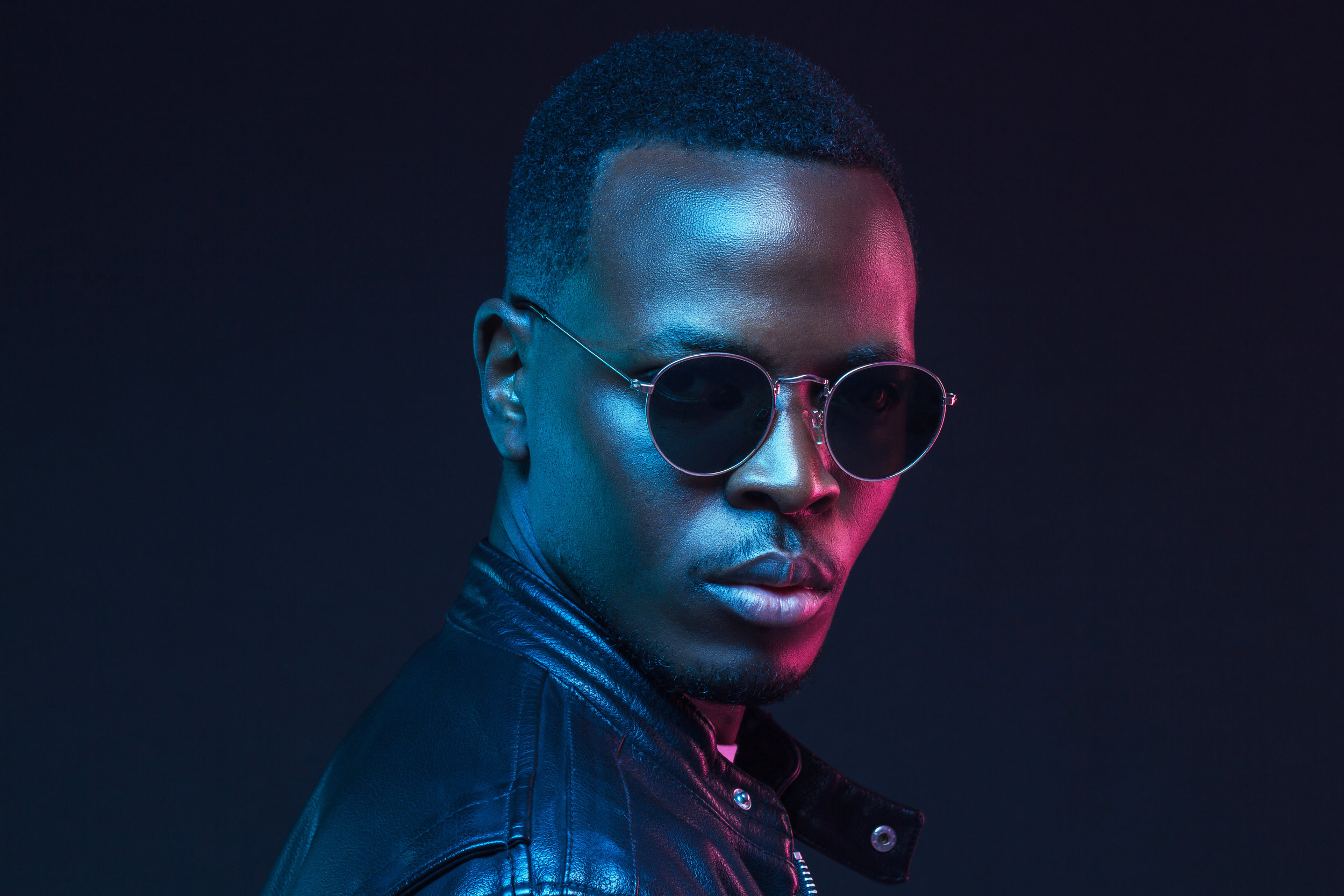 African male model portrait, wearing trendy sunglasses and leather jacket