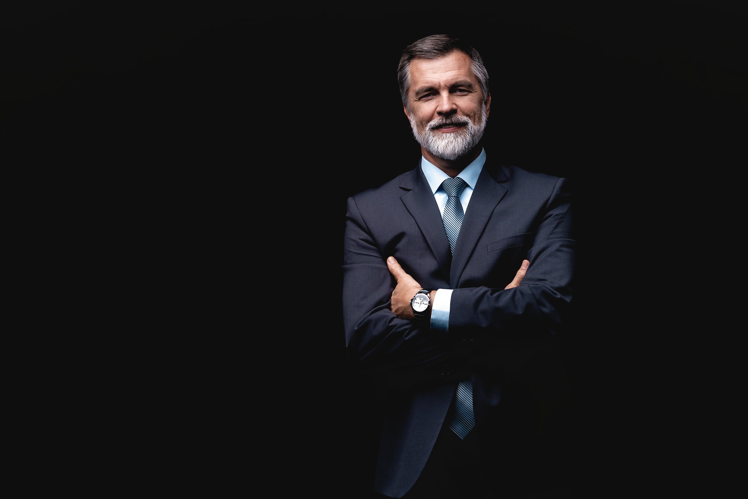 Handsome mature business man isolated on black background