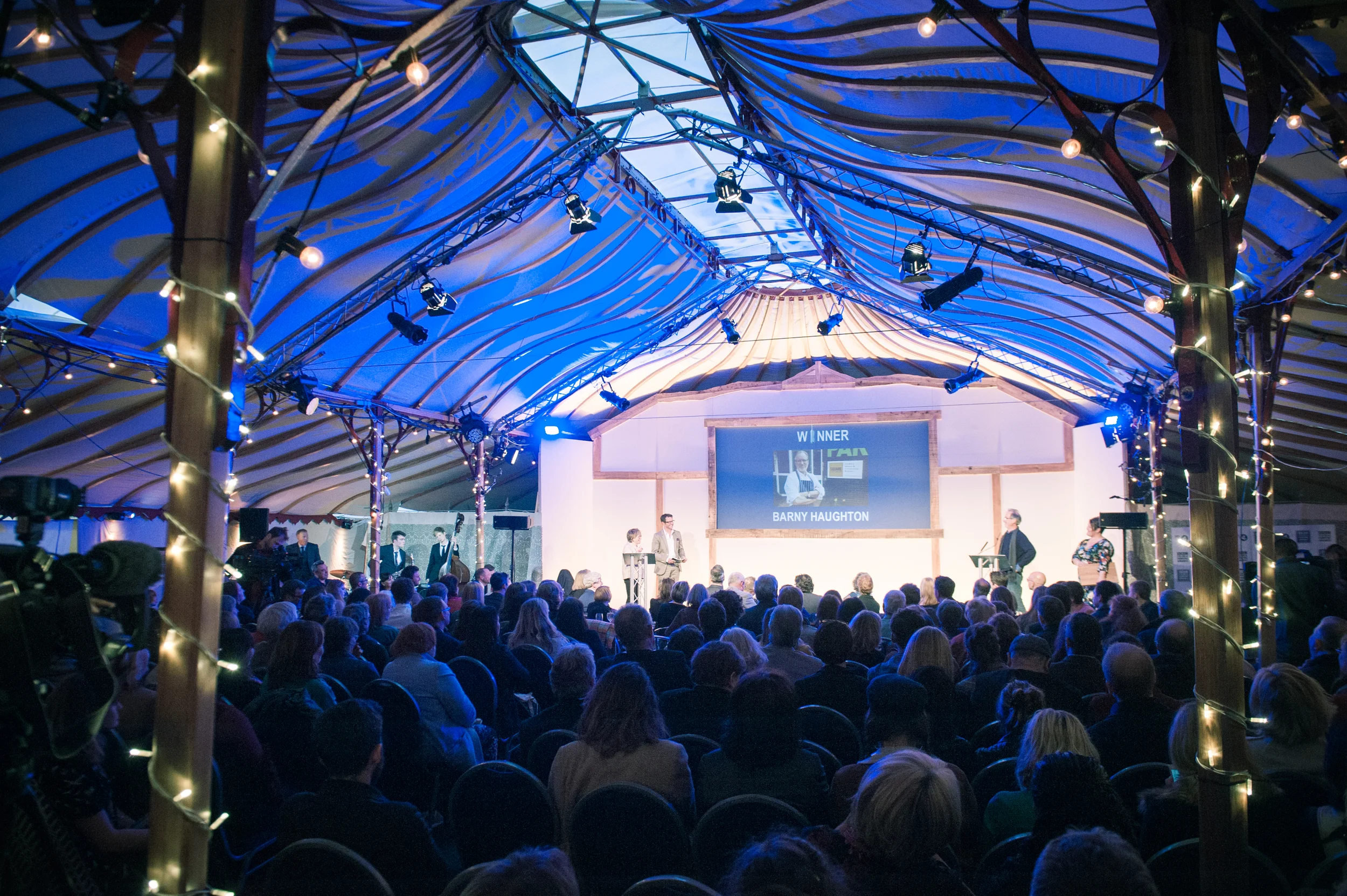 Barny on stage after receiving his award at Radio 4's Food & Farming Awards. Credit Artur Tixiliski/Bristol Food Connections 