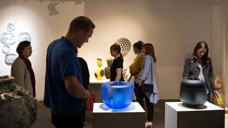 Visitors to the Taste Contemporary stand at TRESOR Contemporary Craft enjoying work by Paul Scott, Akiko Hirai, Elisabeth von Krogh, Jeremy Maxwell Wintrebert and Ernst Gamperl.