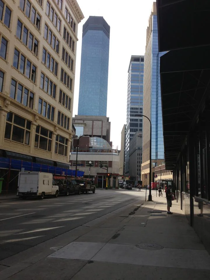 First morning light in downtown Minneapolis. Light reflected and falling on the still shadowed street.