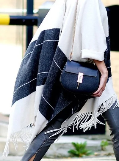 Hygge fashion is demonstrated by the blanket-dressing trend.