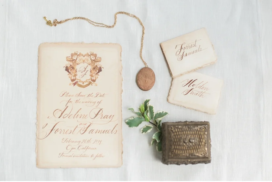 12. This wedding invitation topped with ornate crest brings some serious elegance to the party! Calligraphy by Julie Song Ink and photography by Vasia Photography for the Moda e Arte workshop . View the full feature on Vale + Vine here .