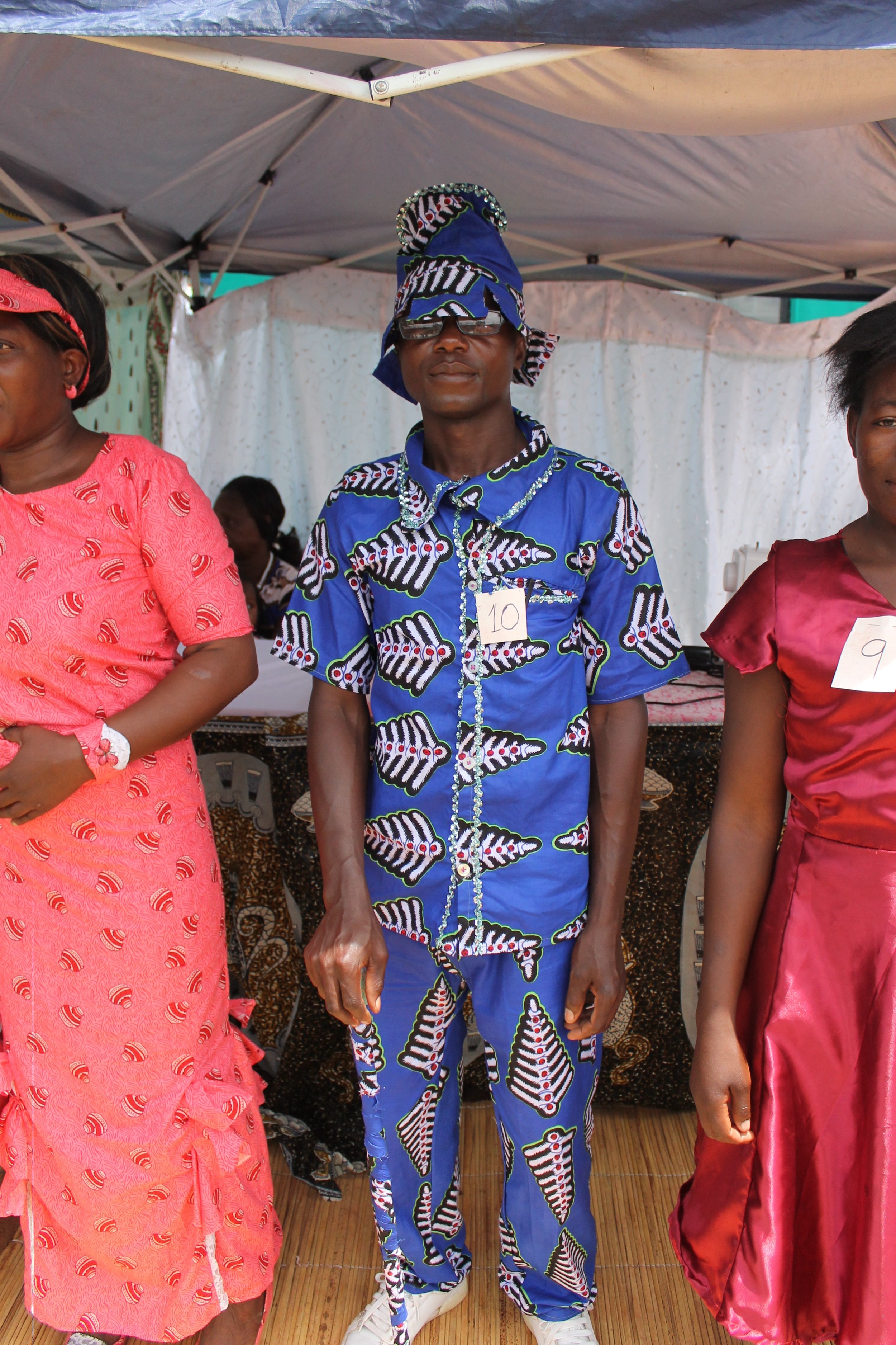 Our only male graduate, Aaron, receives thunderous applause, cheering, and shouting for this incredible chitenge suit, complete with sequin trim and a matching cane + hat combo. 