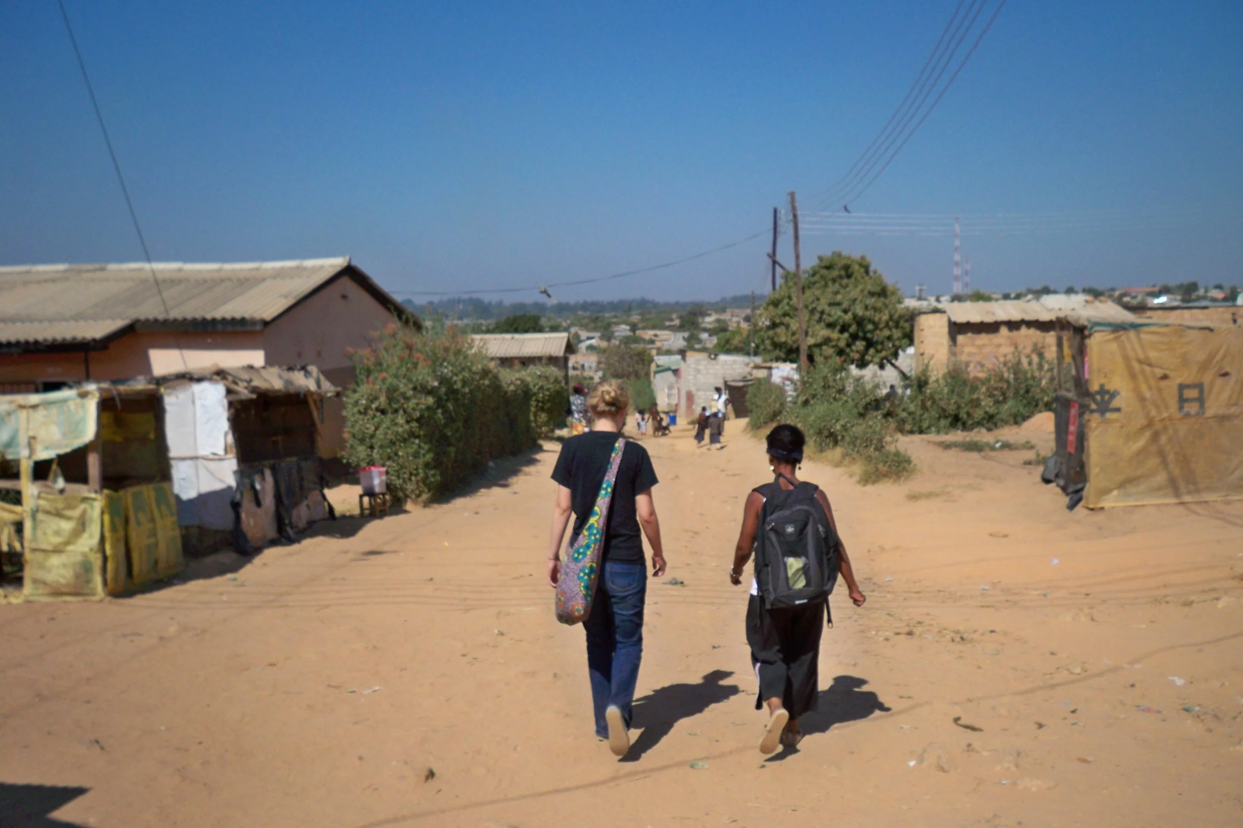 Amy and Elina walking through the Ng'ombe Compound in 2011 at the very beginning of Clothed in Hope.
