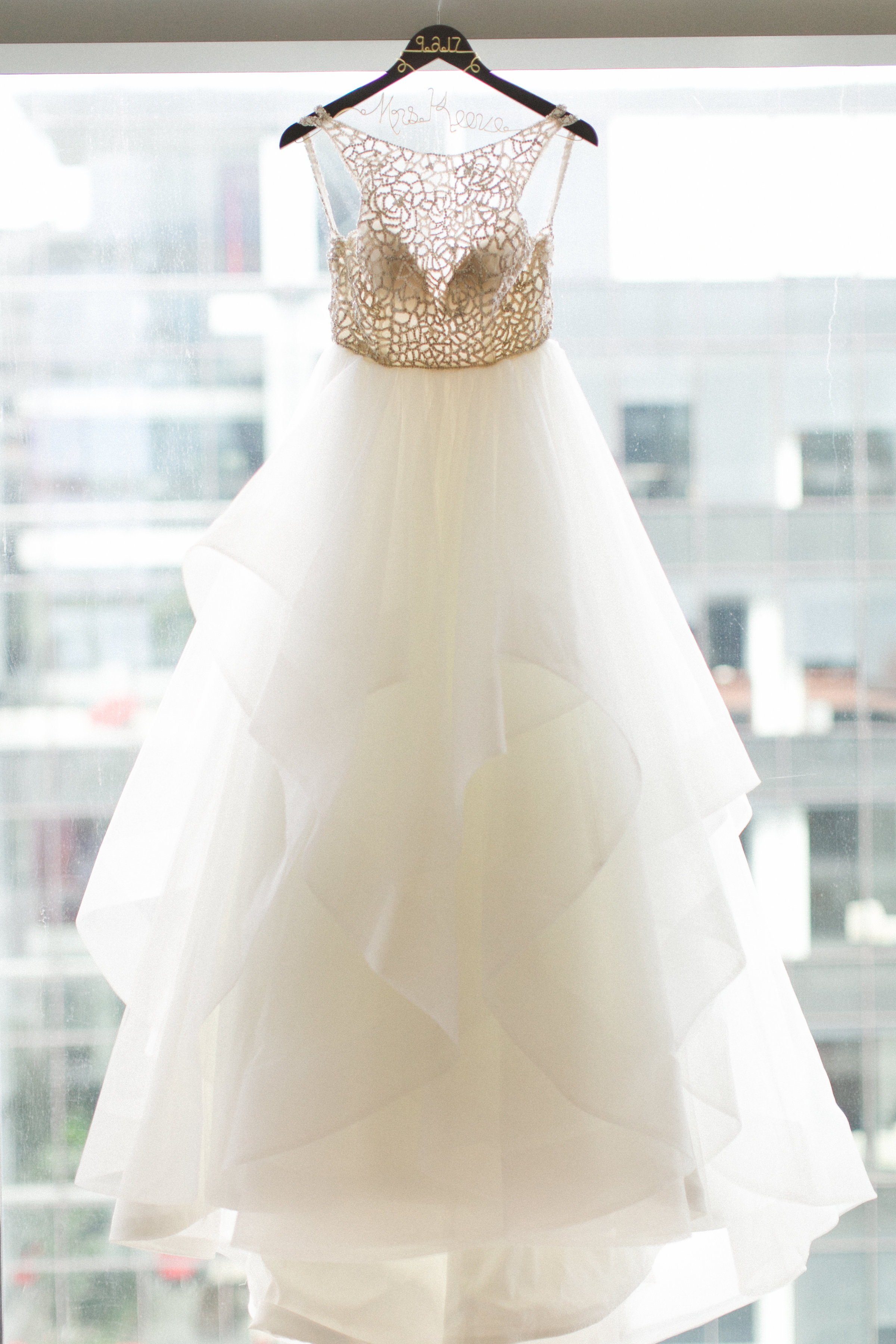 wedding dress hanging in window