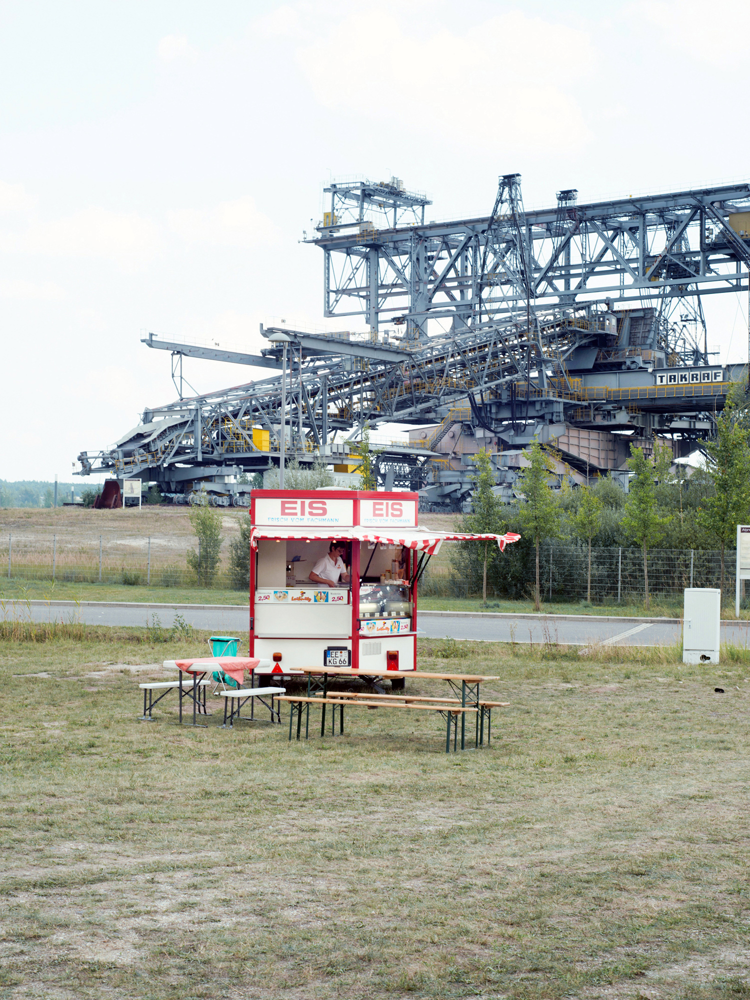  Ice Cream Stall  A stall is selling ice cream in front of the conveyer bridge F60. Since 1992, the bridge has not been in use and has been converted into a visitor center to teach about the region’s mining history. 