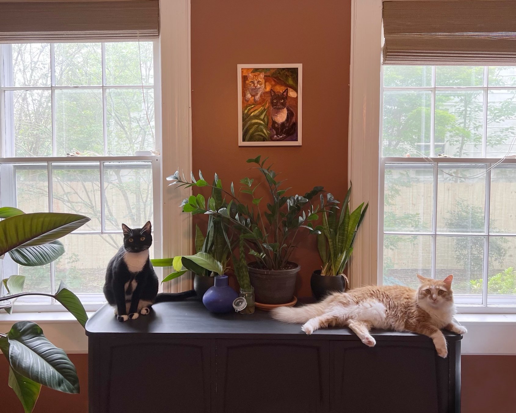 Two satisfied clients with their portraits.