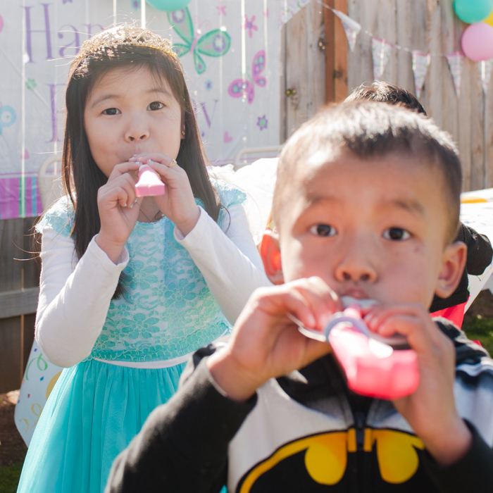 birthday girl, Z., and Batman with party horns