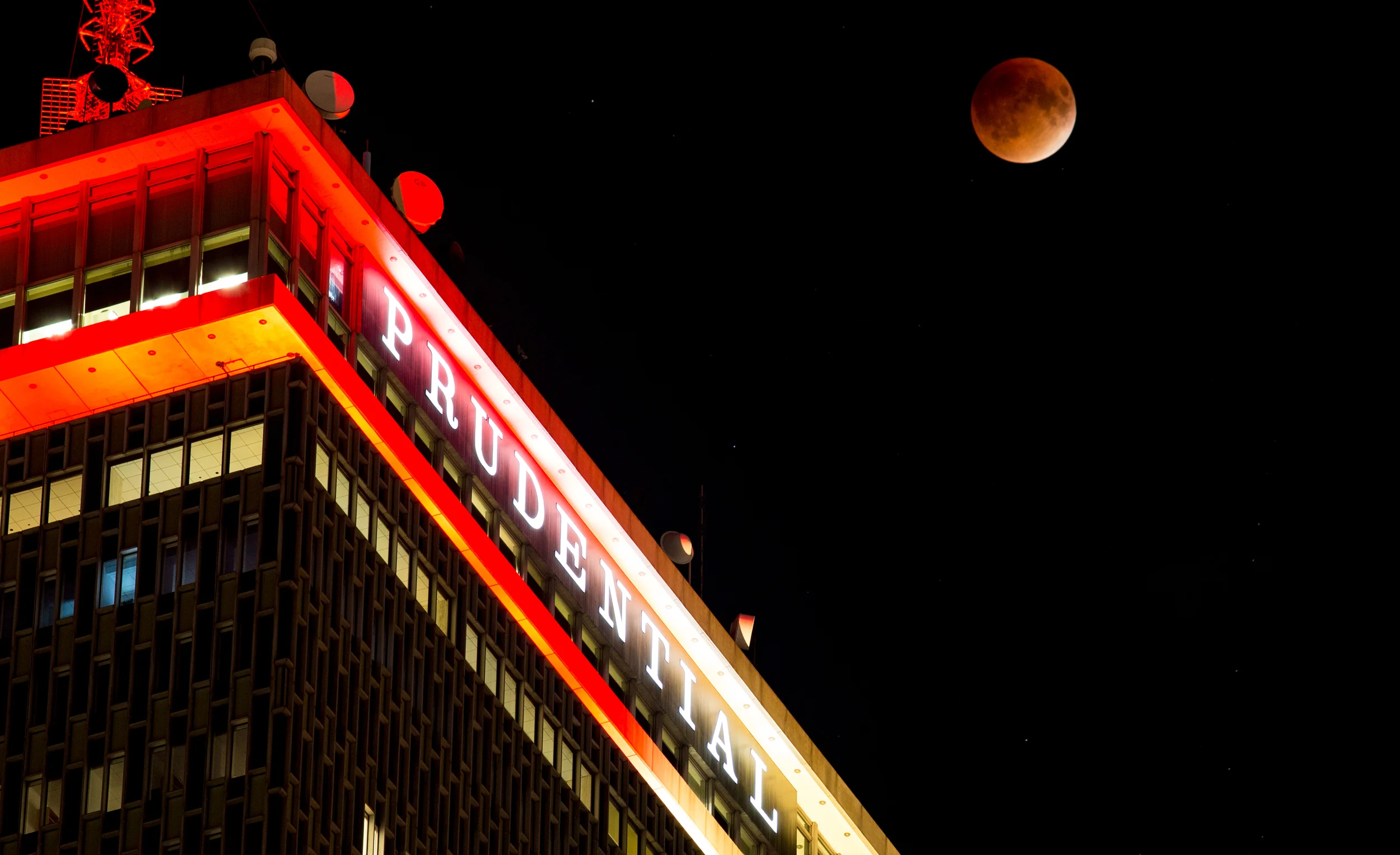 Wider shot of the Super Blood Moon over the Prudential Building in Boston