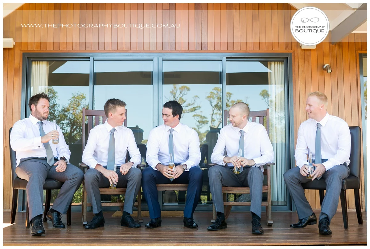 groomsmen sitting on verandah at chandewliers on abbey wedding