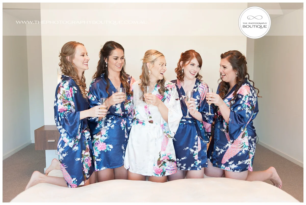 bride toasting with bridesmaids in special dressing gowns