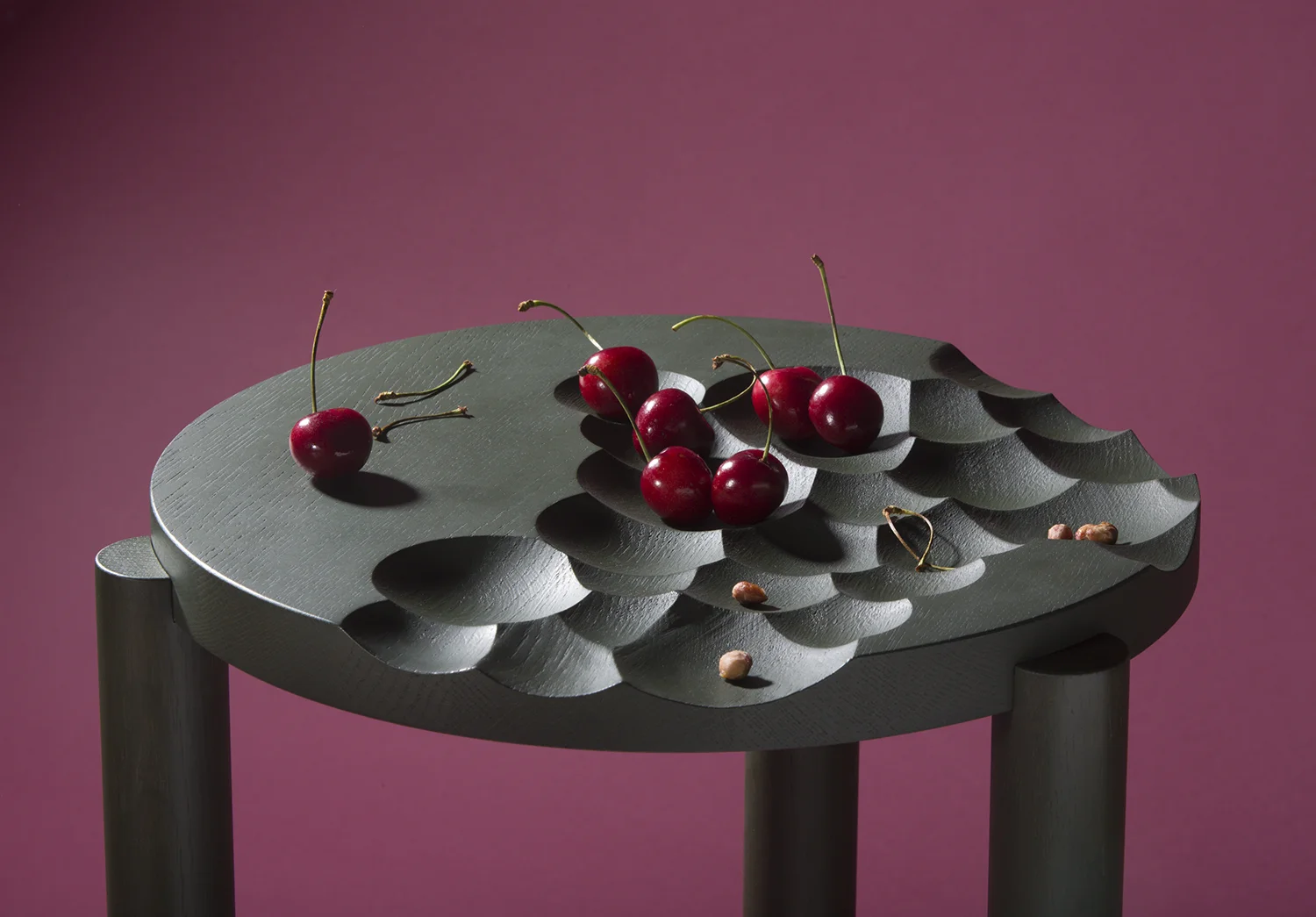 Dune Tables and glass details, Klong Limited Edition Anniversary Collection, 2016 The three dimensional pattern impeaches on our preception of a traditional table, stirs the mind and encourages the unconventional. The hand blown glass bowls fit the indentations on the surface and can be shifted around. Dune is as much a table as a decoration in the room. The tables are made of stained oak, including glass bowls. The Dune set comprises of four tables and seven glass bowls with a limited edition of five copies. Price: 40 000 SEK Dune is a part of Klong's limited anniversary collection, launched August 2016; "We celebrate 15 years by presenting an anniversary collection consisting of four seperate objects, produced as special limited editions. We have created this collection to illustrate our ambition to be a part of Sweden’s continued quest for innovation and sustainability, combining creative art and fine craftsmanship. Our objects demonstrate a unique expression." Material: green-stained oak and hand blown glass details Table 1: Ø 360 mm, h 395 mm Table 2: Ø 360 mm, h 430 mm Table 3: Ø 360 mm, h 465 mm Table 4: Ø 360 mm, h 500 mm Glass bowl, small: Ø 90 mm, h 60 mm Glass bowl medium: Ø 110 mm, h 70 mm Glass bowl, large: Ø 130 mm, h 85 mm Photo: Petter Brandt