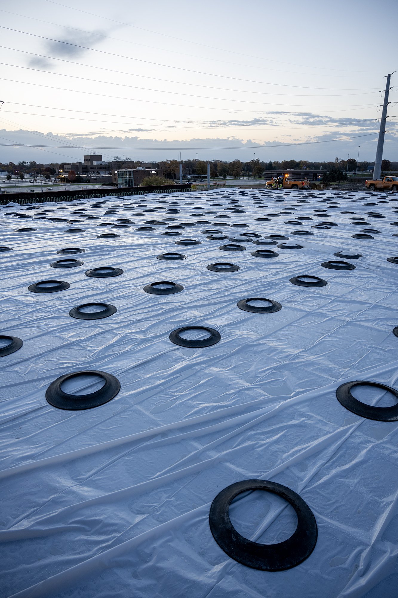 Newly poured concrete bridge surface covered in plastic to aid curing before rains