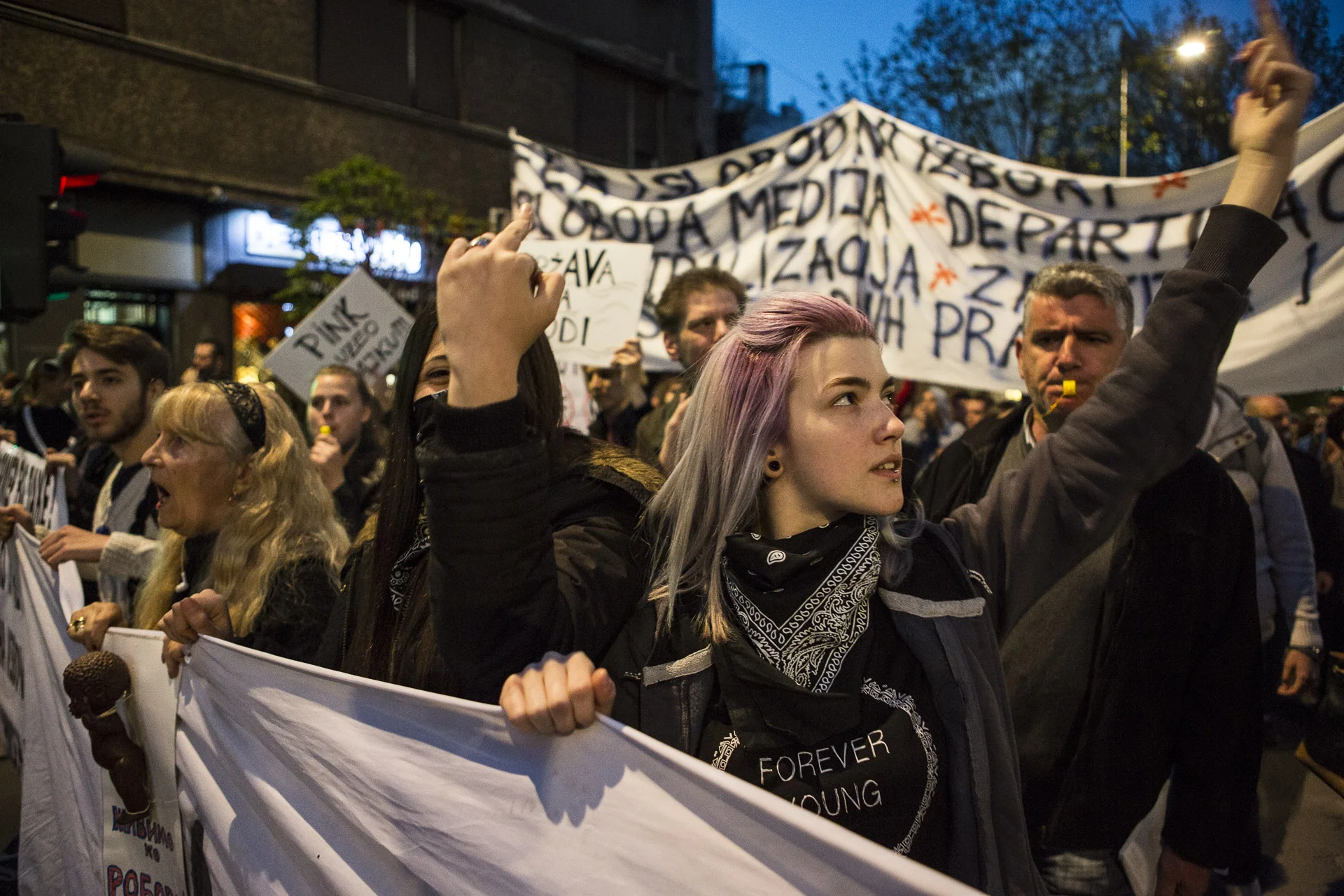 Young protesters in front of an institution building.