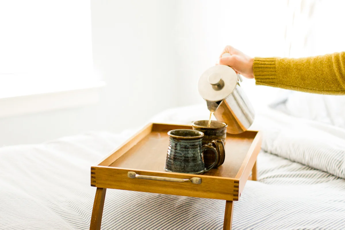pouring coffee in an intimate in-home couples or engagment session in kansas city, MO