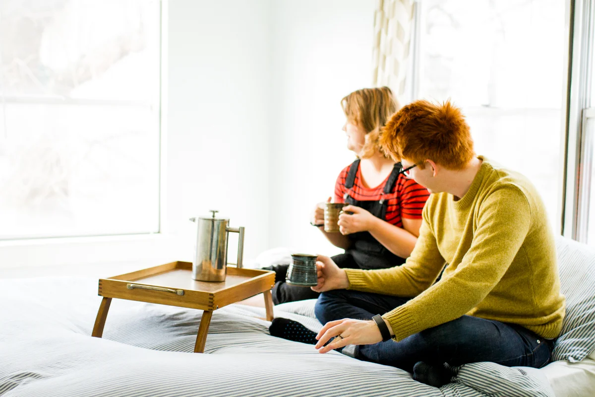 having coffee together in bed during an intimate in home couples session in kansas city, MO